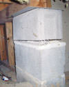 Concrete crawl space support posts in Windham that are showing signs of failure as they sink into the earth.