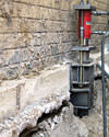 A completed installation of foundation push piers lifting a foundation in Gorham
