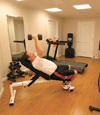 a basement gym and workout room with a wood laminate flooring, installed in Dover, ME and NH