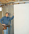 Installing wall panels on top of our basement wall insulation in Augusta