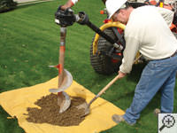 Auguring a hole in the earth for a foundation repair in Scarborough