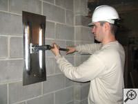 Attempting to straighten a bowed foundation wall by straightening a wall anchor system in a Auburn home.