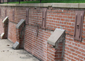 Rusted wall plate anchors in a retaining wall repair in Old Town.
