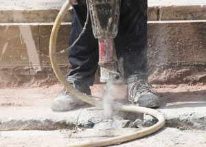 Jackhammering a slab floor in a South Portland home.