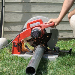 Cutting the support beam for a crawl space jack post outside a Auburn home.