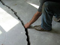 a severely damaged cracked concrete slab floor in Bath