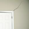 A long drywall crack beginning at the corner of a doorway in a Bath home.