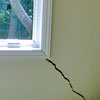 A long, diagonal crack that begins at a window corner of a Gardiner home