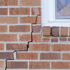 long jagged cracks starting at the corner of a window along a brick wall on a Windham home