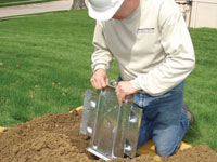 Fastening an earth anchor for a severely bowing wall in South Portland.