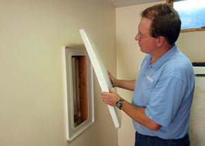 Foundation wall anchor covers installed in a finished basement with a repaired foundation wall in Skowhegan.