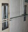 Foundation wall anchor plates installed in a basement in Rochester