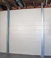 A steel i-beam system installed on a Exeter foundation wall