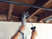 Straightening a foundation wall with the PowerBrace™ i-beam system in a Biddeford home.