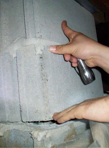 a completely failing concrete crawl space support pillar in Falmouth