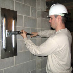 installing a wall anchor to repair an bowing foundation wall in Biddeford
