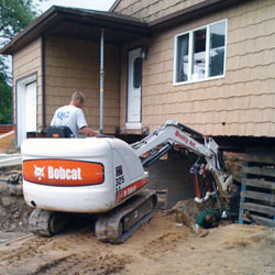 Excavating to expose the foundation walls and footings for a replacement job in Brunswick