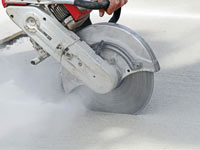 Cutting the driveway for expansion joints during street creep repair in Yarmouth