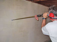Drilling the hole in the foundation wall for street creep repairs in York