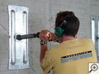 Mounting the steel wall plate for foundation wall repair and straightening in Somersworth.
