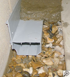 A no-clog basement french drain system installed in South Portland