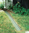 A recessed gutter drain extension installed in Falmouth, Maine