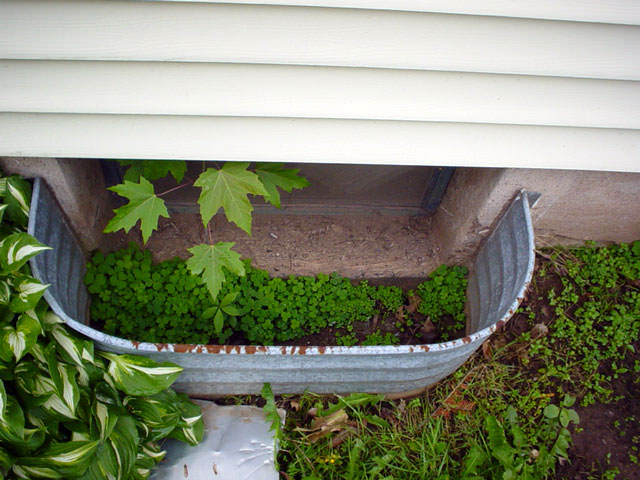 Energy Efficient Basement Windows Installed In Bangor Portland An Old Metal Basement Window Well Showing Signs Of Rust And Corrosion In Biddeford