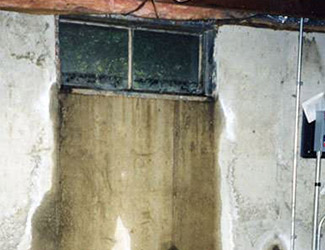 Water pouring out from a basement window in Portsmouth